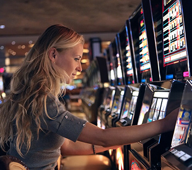 Woman playing a slot machine.