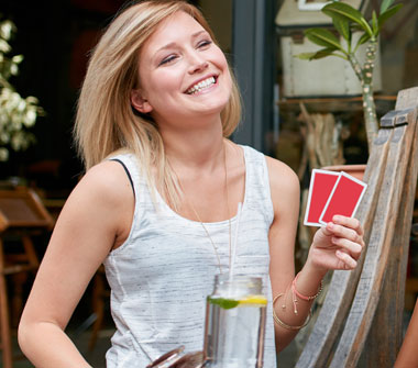 Group of friends having fun while playing cards.