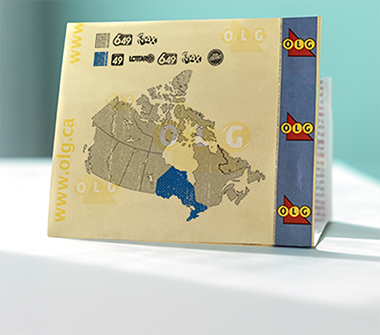 The map of Canada is printed on a lottery ticket showing the different lotteries played. The map of Ontario is highlighted in blue differentiating which games are only offered within the province.