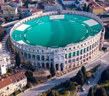 The Colosseum is shown with an enlarged poker chip inside.