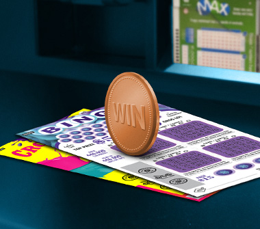 Two Instant scratch tickets are on top of a scratch ticket display case, and a bronze-coloured coin with the word “WIN” on the face is above the tickets.