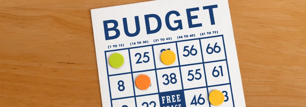 Bingo card, reading BUDGET, on table.