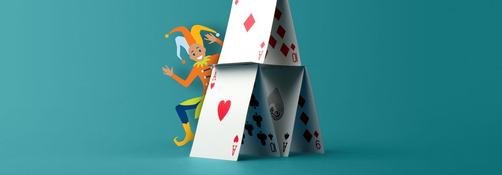 Joker behind a house of cards.